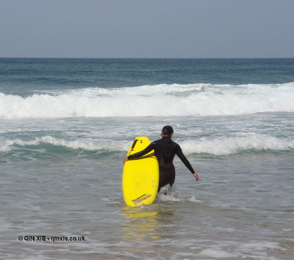 Qin Xie heading out to surf